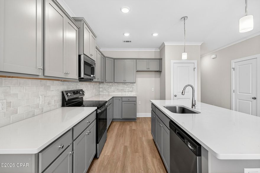 NO RENTAL RESTRICTIONS!!! Our stunning pool is NOW OPEN! The prefect place to SOAK UP THAT Florida SUN! Seagate at Clara is a new townhome community nestled in the vibrant city of Panama City Beach, FL. This two-story unit features board and batten exterior and covered entries. One car garage provides a great space for storing beach essentials. This open concept townhome boasts a stylish kitchen with white cabinets, tile backsplash, a large island with quartz counter tops - perfect for entertaining.  The elegant Owners Suite is designed with comfort in mind showcasing a large walk in closet and double- bowl vanities. Main Bath has tiled shower.  All bathrooms have quartz countertops.  LVP is located throughout the home.  The community pool features a cabana, lounging, seating and grilling stations. This community has a dedicated dog park. Seagate at Clara is in a prime location, approximately 1.4 miles to the sandy beaches and just minutes from Pier Park.