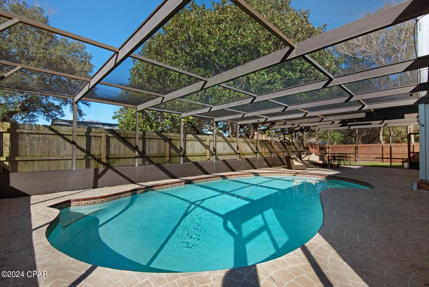 A must see if your looking for a central location for your family home close to shopping, dinning and great schools. THIS IS A 3 bedroom/2 bathroom home. Master bathroom has a recently updated tiled shower with glass doors and new vanity. Interior was recently painted with new flooring throughout and there is a new vanity in the full bathroom. Seller's installed new ceiling fans and new light fixtures. Home also features wood burning fireplace and a beautiful inground pool with a large screen inclosure with a great paver patio to have your family gather.