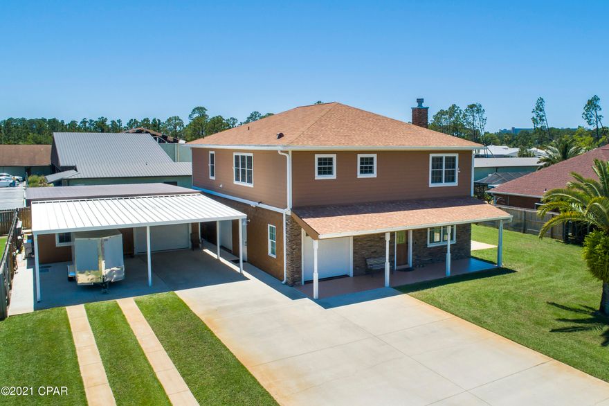 UNDER CONTRACT WITH CONTINGENICES, SELLER ACCEPTING BACK UP OFFERS.

Custom-built 3 bedroom and 3.5 bathroom masterpiece located in the heart of Panama City Beach.  This executive home is impeccably maintained with custom finishes only found in the most exquisite residences in the nicest neighborhoods in Panama City Beach.

Custom features of this home include a trey ceiling in the living room, premium crown molding, custom 18-inch tile in the kitchen and bathrooms, custom kitchen cabinets, tiled bathroom showers, and hardwood floors in main living areas. The first level of this home contains a room that could serve as a living room or entertainment room.

This room has a massive ''movie-style'' projector screen that comes down discretely from the ceiling for the ultimate in entertaining. In addition to having a massive amount of room for entertaining on the first level, there is a full bathroom and IT room for servers, and computer hardware.
As you ascend the stairs to the second level, you will notice that the upstairs flows seamlessly from one room to another.
The living room is perfect for entertaining and open nicely into the kitchen with granite countertops, granite kitchen island, and stainless steel appliances including a new dishwasher.  The laundry room is located just off of the kitchen with newer washer and dryer (both washer and dryer convey with sale).  The master bedroom has two oversized his and hers closets, and an en-suite bathroom with his and hers sinks and all custom cabinetry.  
The two guest bedrooms share a hallway bathroom with tiled shower and tub.
The exterior of this home is immaculately maintained with new exterior paint, upgraded irrigation system, and recently pressure washed.  The front patio was just painted and the garage floors are painted.  The garage of this home is a dream with custom shelving and tons of space for golf carts, mowers, and lawn equipment.  The HVAC system is only 5 years old.  There is a  carbon filter on the water system that only needs to be replaced every 5 years.  There is a 1-ton heat pump for the office and a 2-ton heat pump in the main shop area.  The technology in this home is second to none with wiring for cameras and alarm system and pre-wiring for a pool.
The construction features of this home are astounding and here are some of the jaw dropping features:  main structure first floor has split faced concrete block with #5 rebar in every cell which is poured solid.  The second floor has 2x6 framing with Pro Bolt anchoring system, 5/8" rods every 4 feet and within 1 foot of every door.  5/8" plywood sheathing on 2nd floor exterior and roof deck.  Hardi-board siding on 2nd floor and detached building.
New 25-year roof rated for 150 mph wind with transferrable warranty.  Anderson windows.  Detached building is 2x6 framing with 5/8" Pro Bolt anchoring system with 3/4" plywood exterior walls and roof deck with metal roof.  Attached carport has 5 insulated garage doors (2 garage doors on the main house, and 3 garage doors on the detached building).  The detached building is set up as an office and shop.  
The shop can be converted to extra living space.
You have to see this home to understand the premium craftsmanship and construction.  Come see this home, and make it your very own!