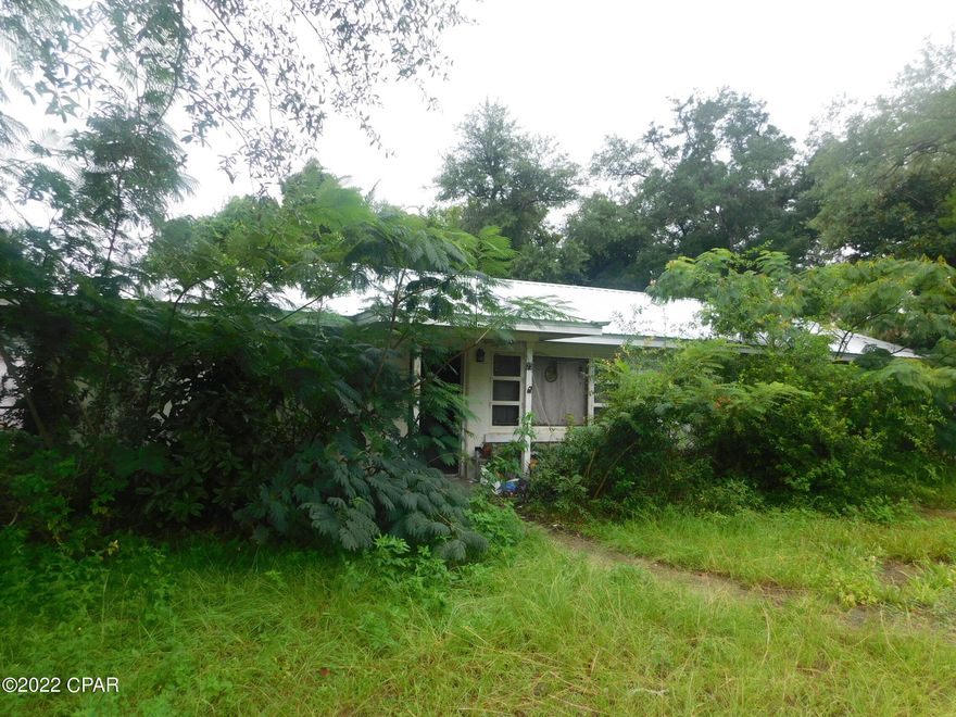 Larger older three bedroom one bathroom block home with bonus room, all needing some tender loving care offered as is.  The home has a a  one car detached one car garage currently used as living space that is not reflected in the heating and cooled space. The location is near Tyndall Air Force Base, Highway 98 and walking distance to the bay,  All sizes are approximate or taken from other sources please verify accordingly.  Seller is planning on only taking the items in the living room and garage.