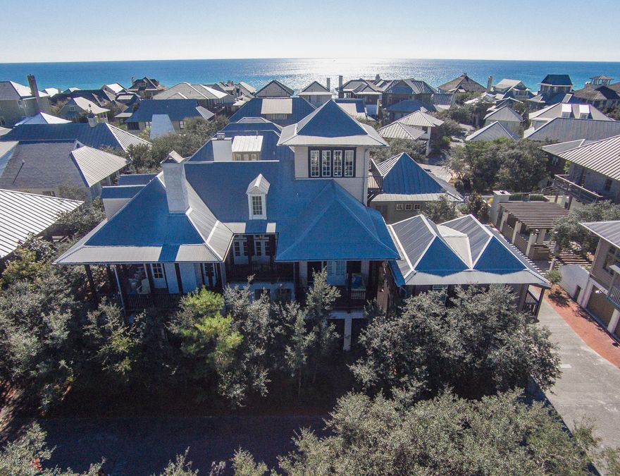 Seated in the midst of the spectacular scenery of the gulf front community of Rosemary Beach, “Impulse Buy” overflows with refined luxury, warm accents & rich architectural detail. Using New Orleans for inspiration, noted architect Eric Watson, created ample porch space & used dark elegant trim, rich hardwoods & gas lanterns to create a warm & inviting home.  

As the results of a recent partial renovation, the property has gone from 6 bedrooms, 4½ bath to a 7 bedroom, 5½ bath, 4000sf compound that includes a full 1 bedroom, 1 bath carriage house. With 7 large comfortable bedrooms, “Impulse Buy” is the perfect legacy house for future generations or a dynamite investment property with outstanding rental potential. Offered rental ready, beautifully furnished & ready for you to enjo The living room is tastefully appointed & features 16 ft high ceilings, rich dark wood floors, windows on both sides allowing natural light to flood the space & multiple doors leading to a large softly light porch overlooking a boardwalk  & creating the ideal setting for entertaining guests or relaxing with the family. The large gourmet kitchen with granite counter tops opens into the expansive living space and offers a Viking hooded range, GE Monogram refrigerator, Bosch dishwasher and generous cabinet space. 

The first level of the home contains two spacious guest bedrooms and a shared roomy bath in additional to the first of 2 master suites.  Both guest bedrooms are complete with shaded outdoor porches while the master offers a private sleeping porch.  The 2nd level  master suite features a private balcony with a hanging bed for those mandatory afternoon beach naps.  The final two bedrooms in the main house are located within the privacy of the third level of the home.  

Follow the spiral staircase up to the lovely sunset room in the tower.  This tower is special as it is only one of less than ten approved for construction on the south side of Rosemary Beach. Ultimate relaxation can be found in this tranquil space complete with cocktail bar and panoramic views of the Gulf and the beautiful architecture of Rosemary Beach.

Above the air-conditioned 2 car garage is an artfully designed carriage house with a full kitchen, living room and separate bed and bathroom.
One of the most desirable traits of this property is the abundance of outdoor living space.  The balconies on each level of the home offer shaded retreats and are the perfect places for enjoyment of the Gulf breezes; a quaint portico leads to a shaded stone courtyard with a charming fountain ideal for outdoor dining and entertaining.  16 gas lanterns are spread throughout the exterior of the home setting an elegant ambiance.

Rosemary Beach offers some of the most lush parks and greens along 30A with 5 pools (one is owner's only to be completed spring 2015), hiking trails, a fitness center, yoga studio and clay tennis courts. The shopping and dining experience is unparalleled with arguably some of 30A's best culinary destinations and most unique boutiques. A robust events program entertains families throughout the year with movies, festivals, a farmer's market, concerts and much more. And of course the wide stretch of sugar white sand and glittering turquoise Gulf waters complete this quintessential beachfront town.