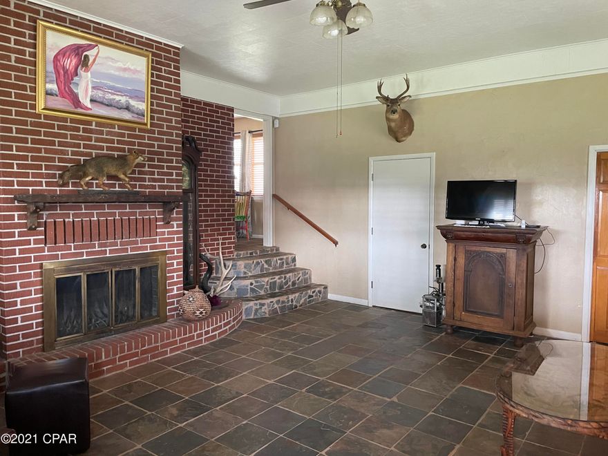 Privacy!  This 2.65 acres with a 3/2 brick home sits on top of a hill. The views from this hilltop are spectacular!  This home has a large great room with wood burning fireplace, a large living room/dining room combo and an eat-in kitchen.  This property includes a separate 20x30' workshop with 220/240 hookup and a mini-split unit for air/heat.  Also included on the property are 2 storage containers.  

There are a number of pear trees, persimmon trees, pecan tree and a blueberry patch.   This one will not last!