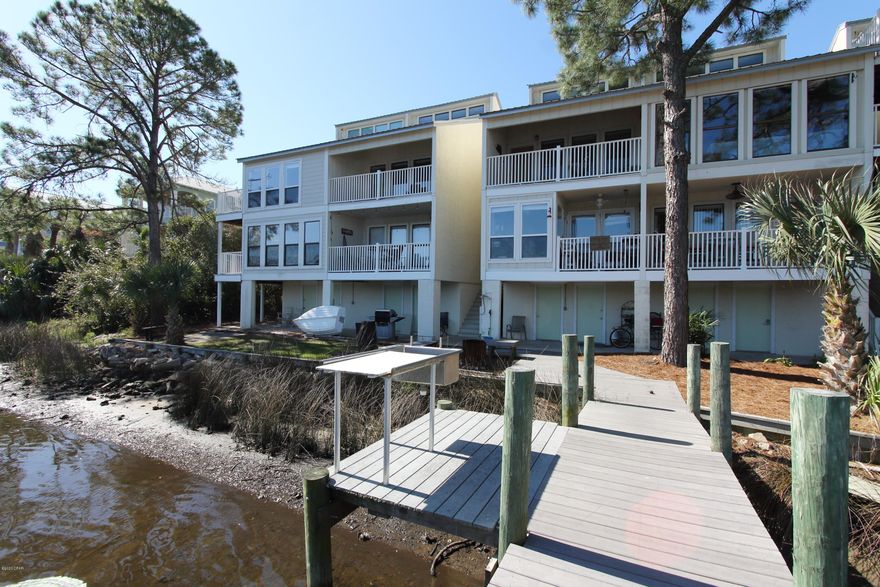 Waterfront with prime boat slip and boat lift on Grand Lagoon. Minutes from the Gulf. End unit with sunrise views. Updated kitchen with quartz countertops. Storage underneath main floor. Completely furnished. New mattress and living room sleeper sofa. Special Assessments of $2000 due January 1, 2021 and January 1, 2022.