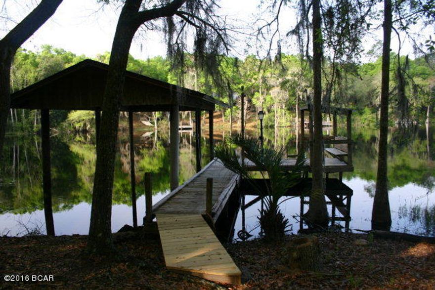 Beautiful waterfront home on Gap Lake. This comfortable 2 bedroom 1 1/2 bath home sits on 2 acres of peninsula type land high on a bluff. Home is well designed to take advantage of the views offered by the lake. Home lives larger than the indicated square footage. Features spacious living area with a fireplace and views of the water. Kitchen is well laid out and also features views of the water. Bedrooms share a jack and jill bath and there is a second guest half bathroom in the hallway. One car garage with auto garage door opener. Garage could be converted to a 3rd bedroom if needed. Enjoy the day outside on the two level deck, or relax in the comfort of the screened room. Wander down the stone pavers to the fishing dock and covered boat house. Gap Lake is well known for the great bass fishing. Lot is lovingly landscaped to enjoy the serenity of waterfront living. Home is set well back from the road to enjoy privacy. Make your appointment to see this one. I am sure you will not be disappointed!