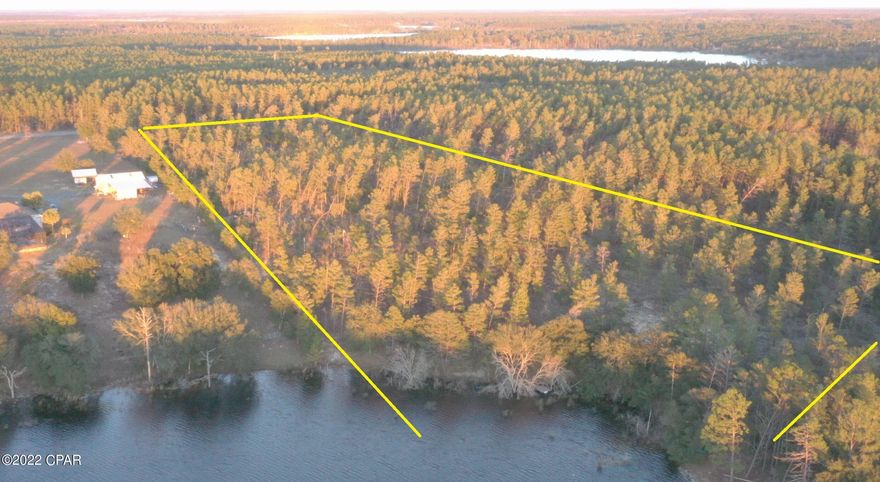 Largest lot ON THE LAKE! 12.6 acres, Sunset views year round over Piney Lake. You can also subdivide the property and build 3 homes. Comparable lot that sold recently is 7 lots down to the west only 4.7 acres  on a steep embankment but sold for $110,000 on 7/27/22! We are almost 3 times that size.  A well looks to be already drilled on property but it has not been tested (see pictures). Address right next to this property is 2073 Rolling pines to help you GPS.  Trails on each side of the property line from the road are wide cut and many paths and trails cut through the closer you get to the water to help explore. Currently many planted pines on it and some beautiful large oaks at the water line