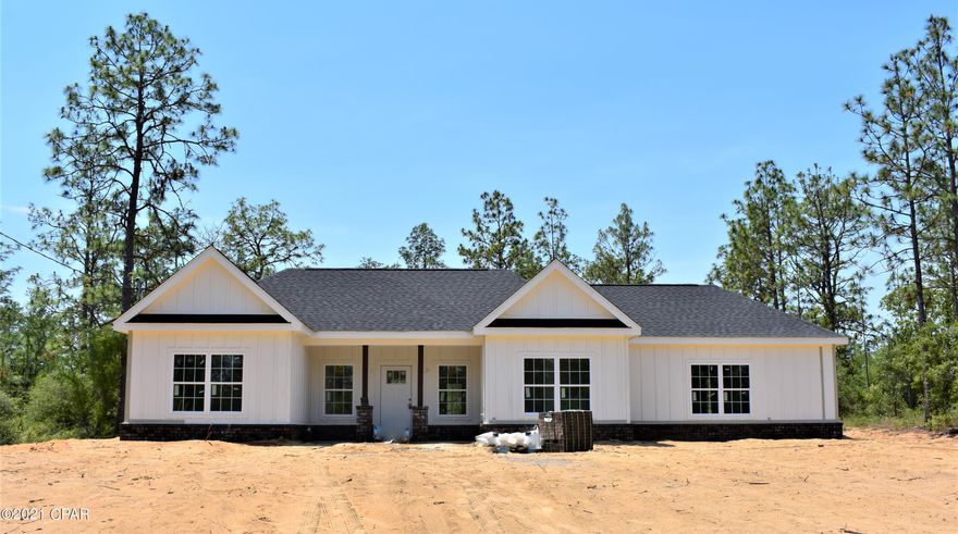 *Under contract- taking back up offers* New Construction home, will be complete in about 30 days! This Jubilee home features 9 ft ceilings throughout, vaulted ceiling in living and kitchen area, kitchen island will be a darker gray as well as the guest bath vanity, master vanity will be walnut color, master garden tub has a chandelier over it that is dimmable, tile flooring throughout home is gray wood look and master bath is marble look tile on floor/shower/garden tub wall area. Interior paint will be a light gray. There will be a circular driveway in front and a 10 foot by approximate 20 foot slab off back of home. Sellers request to not park/drive on driveway once it is poured, cones will be up. Sod will be placed around home. Own a new home in the Sunny Hills subdivision and enjoy all the ammenities it has to offer, such as, golf course, lakes for boating and fishing, community center, library, and more! Just a 45 min drive to the Worlds Most Beautiful Beaches and shopping at Pier Park! 
Home will have a 1 year builders warranty through Jubilee.