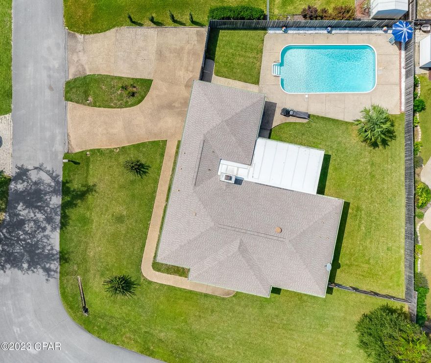 Beautiful move in ready home located in a quiet, friendly neighborhood close to Tyndall Air Force base, schools, parks, boat launches, and shopping. The open front porch and well-maintained corner lot has great curb appeal and is an inviting site to friends and visitors. The walls throughout the home are painted with neutral colors that will match any home décor. Enjoy family get togethers or game night in the huge open family room and kitchen with a breakfast bar. Kitchen has plenty of counter and cabinet space central to the dining room, family room and laundry room. Have relaxing quiet evenings sitting around a wood fire in the custom stone fireplace. Large master bedroom easily fits a king size bed with attached full bathroom and double French doors that lead out into the screened in porch and pool. The open living-dining room combination is perfect for family meals and a quiet place to entertain company. The privacy fenced back yard and screened in porch are great for BBQs and swim parties Newer roof and water heater with a high efficient heat pump and ceiling fans in most rooms. Large 2 car oversized garage that leads into the laundry/mudroom and ½ bathroom. Driveway has a circle driveway and plenty of space for your boat or camper. All measurements are approximate, please verify if important. Call your favorite Realtor® for a showing today.