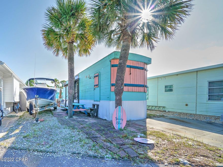 Great opportunity to own in one of the best locations within Venture Out. Highly sought-after Treasure Isle is a quiet circle that everyone loves.  Home has hurricane Michael damage and value is in the lot. Build your dream home or remodel. Venture Out is a golf cart community that has exploded with popularity recently... With 300' on the beautiful pristine beaches of the Gulf of Mexico and 1,000' on the Grand Lagoon. Venture Out has something for everyone. With 2 pools, fishing pier, boat ramp, mini golf, children's playground and much more!