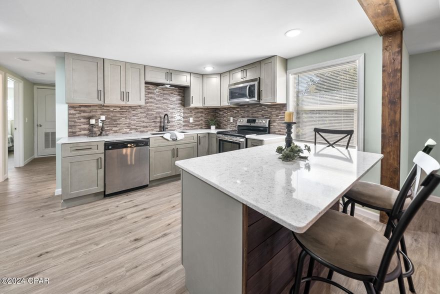 Under Contract - Taking Backups the phrase 'CURRENTLY UNDER CONTRACT, SELLER WILL CONSIDER BACKUP OFFERS'  LOCATION, location! No HOA, plenty of property to put in a pool, build a huge shop or even add another residence.  This home has been totally renovated. 3 BR, 2.5 Ba, 1530 sf. all brick. In a country setting totally private on over 3/4 acre. Its location is a few blocks from the bay, 12 min to the sandy beaches of pcb and in the area where homes are way above my asking price. The shopping strip is also a few blocks away. Areas located near this home is Kings Ranch, Kings Point and Sweet Bay.
Renovations include: new wrap around porch, windows, elec, plumbing, doors, septic, ext paint, landscaping, lvp floors, ductwork, insulation in total house, tankless hw heater, granite counter tops,  easy close kitchen cabinets, master en-suite, barn doors, interior paint, and kitchen island. HVAC is 7 years old and roof replaced in 2019.