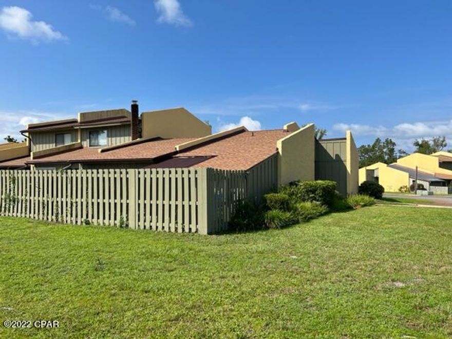 'CURRENTLY UNDER CONTRACT, SELLER ACCEPTING BACKUP OFFERS' Dellwood is a quiet, well kept community located centrally for quick access to 23rd St. as well as 15th Street. This end unit is a single story 3 bedroom/2 bath large unit. It has a nice extra room off the living area that could be a den or office space. The back deck/patio area is fenced for privacy.  Parking is right outside the front door and the location is close to the pool and the location of the future clubhouse. The HOA fees are low and long term rental is allowed.