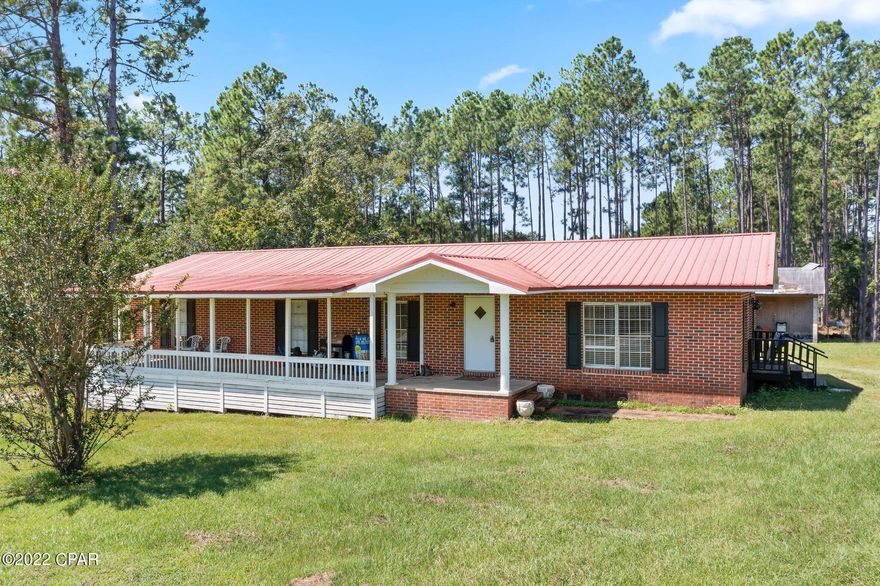 This 4 Bedroom 2 Bath home is located in one of the most desirable areas of Washington County. It sits on a high and dry 1 acre lot on a paved road just outside of town. This mobile home has been completely bricked over and features a large front porch for the perfect place to relax and added curb appeal. The interior features a large living area, 4 bedrooms, eat-in kitchen,  2 full baths, a laundry area, and a potential office/flex space. There is also a 52x12 block building on this lot that is in need of some repairs, but could be fixed and used as additional living/rental space. Homes in this area do not come along often at this price point. This could be a great place to raise a family or a great income producing property for the savvy investor.