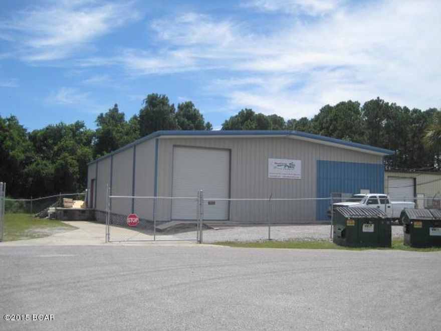 Commercial building with approximately 5,087 total square feet.  About 50% finished area with about 50% warehouse.  Loading dock, fencing, and paving.  16+- eave height.