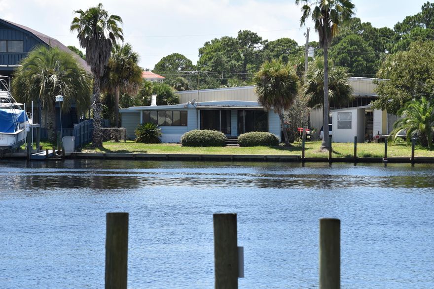 BAYSIDE PARK ... Panama City Beach ... Waterfront property (55' water frontage) situated on lagoon opening directly into St. Andrew's Bay ... minutes to beautiful Gulf of Mexico.  Boat landing within 1 block. 

Excellent location to dining, shopping, entertainment and more! 3/3 manufactured home with 1,752 SF. No HOA fees.  Living Room and Den are directly on water ... wood burning corner fireplace for those chilly evenings. Lots of room in outside storage.  Property has much possibility! Being sold ''AS IS'' with a right to inspections.  All measurements should be verified.  Call today for private showing.