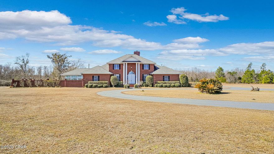 Welcome to a place where space, comfort, and everyday enjoyment come together at 21748 North State Road 71, Altha, FL 32421, in Calhoun County. Set on 13± peaceful acres, this 4-bedroom, 4.5-bath home gives you room to live, gather, and unwind inside and out.

Step inside to a layout designed for real life. The main level features a primary suite downstairs, plus an additional downstairs bedroom with its own private bath, ideal for guests or flexible living. Upstairs, you'll find two more bedrooms, one with a private bath and another just steps from a full bathroom.

Enjoy multiple living spaces, including a formal living room with a cozy fireplace, a great room for relaxing evenings, and a separate dining room for shared meals. The kitchen connects easily to the heart of the home, making everyday living simple and comfortable. Updated hardwood floors add warmth and style throughout key areas of the home.

Just off the living area, the Florida room invites you to slow down and enjoy views of the in-ground pool. With its own separate AC, it's a great spot to relax year-round. Outside, the acreage provides space to spread out and enjoy privacy, with a barn ready for storage, hobbies, or projects.

Major updates include a roof replaced in 2021 and two electric water heaters installed in 2015. Located just about an hour from Panama City, Mexico Beach, and Dothan, AL, this home offers a great balance of country living with convenient access to the coast and nearby towns.

Schedule your showing soon and experience everything this Altha property has to offer.
