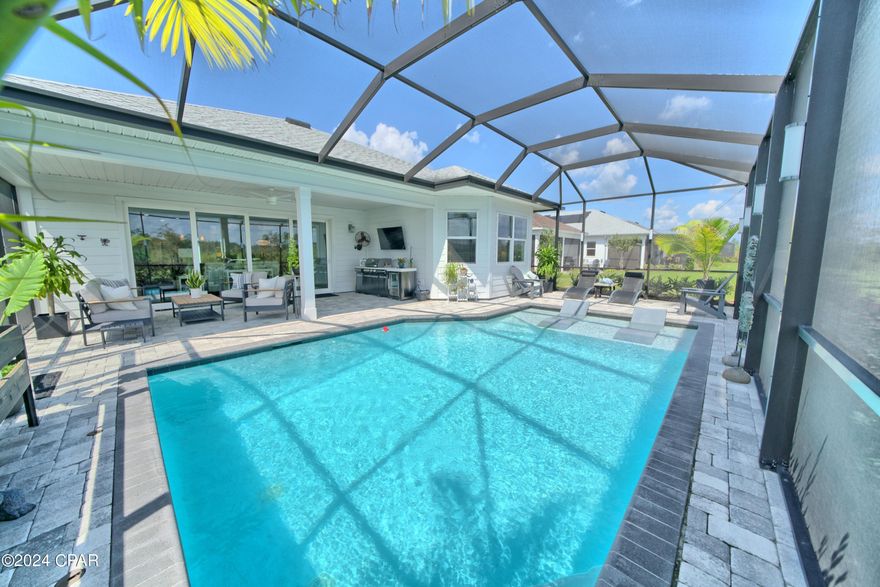 ******HUGE PRICE REDUCTION !!!*****This AMAZING ''BREEZE BAY MODEL'' 2 bedroom 2 & 1/2 bath home has a HUGE OFFICE which could be a 3rd BEDROOM and boast approximately 2170 sq. ft. of LUXURIOUS living space. The home is located close to the ''LATITUDE TOWN SQUARE''on a PREMIUM LOT over looking a pond. The PROFESSIONALLY DESIGNED OUTDOOR LIVING SPACE includes all of the patio furniture, potted plants, patio decor and OUTDOOR KITCHEN ensemble. The CUSTOM SALTWATER POOL is HEATED, has CUSTOM LIGHTING and is screened in for year round enjoyment!. The home has a GOURMET KITCHEN which boasts granite countertops, S/S appliances, gas range, tiled backsplash, under cabinet lighting, large island with pendant & recessed lighting. The BEAUTIFUL interior has vinyl plank flooring throughout, gas FIREPLACE, recessed lighting, tray ceilings, 8 ft doors, a PRIVATE MASTER SUITE with walk-in closets,  master bath with double vanities and a large walk-in shower with a frameless glass enclosure. LATITUDES MARGARITAVILLE WATERSOUND is a PREMIER 55+ GATED COMMUNITY offering an active lifestyle of LIKE MINDED ADULTS and UNSURPASSED AMENITIES. The amenities include the LATITUDE BAR & CHILL RESTAURANT, PARADISE POOL, Fins Up Fitness Center with an indoor pool, several pickle-ball courts, tennis courts, bocce ball, putting green and the list goes on and on! DON'T LET THIS ONCE IN A LIFETIME OPPORTUNITY TO OWN YOUR PIECE OF PARADISE PASS YOU BY!