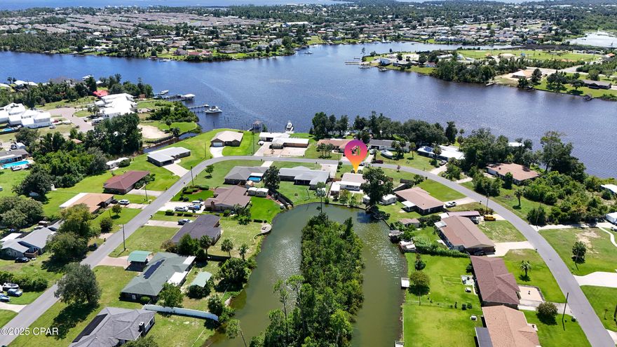 Currently Under Contract, Seller Taking Backup Offers. 6904 Yellow Bluff Road presents a rare opportunity to own a slice of waterfront paradise. Enjoy stunning views from the fully insulated sunroom overlooking your private dock, or take a stroll out back to feed the ducks that thrive among the many fruit trees on the property, including six types of trees: Pear, Peach,  White Peach, Fig, banana,  Persimmon, and 3  Scuppernong vines. This home features four bedrooms and two bathrooms, custom floor-to-ceiling cabinetry, quartz countertops, recessed lighting, and luxury vinyl plank flooring throughout. In addition to the spacious sunroom, the home features a separate laundry room and a large, combined living and dining area. The exterior is brick and is equipped with metal storm/hurricane shutters. There is also a covered utility area and two large outbuildings, often referred to as a ''He Shed'' and a ''She Shed.'' Both outbuildings are sizable at 12' x 25' each and are equipped with numerous electrical outlets. The property offers convenient access with two double gates on one side and a single gate on the other. It includes RV hookups, which could be converted into a charging station, along with a dock. Situated in the county, you will benefit from lower property taxes. The location is near various amenities, including a waterfront park that features baseball diamonds, a playground, walking paths, and a boat launch. Located in the City of Callaway in  Bay County, the area boasts a brand-new, state-of-the-art public pier, a dog beach, multiple parks, restaurants, and gyms. Additionally, Panama City Beach and Mexico Beach are just a short drive away, along with Tyndall Air Force Base, Eastern Shipbuilding, and Port Panama City. Don't miss out on this incredible opportunity! This home is priced to sell. Contact your favorite Realtor today for more information or to schedule a showing.