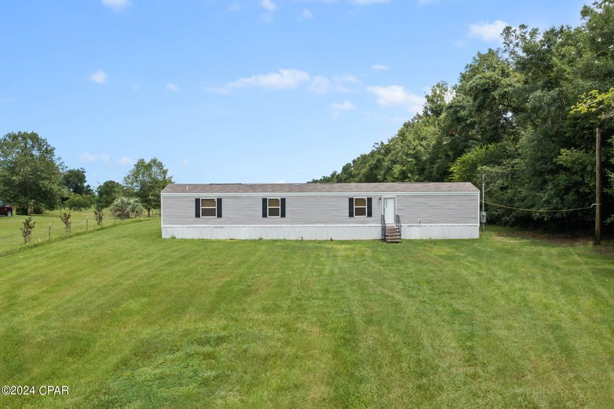 Home Sweet Home! This is what you will want to say after seeing this 3-bedroom, 2 bath 2021 mobile home nestled on a stunning 1.98+/- acres. As you enter, you'll be greeted by a spacious living room that flows seamlessly into the eat-in kitchen, complete with breakfast bar and a versatile flex space-ideal for an office, playroom, or extra storage.  The split floor plan ensures the master suite has plenty of privacy and features a soaking tub, separate shower and walk-in closet. Outside the expansive property provides a serene backdrop for outdoor activities, gardening or simply enjoying the beauty of nature and a storage shed/workshop complete with insulation and electricity. Conveniently located just minutes from Blue Springs and a short drive to restaurants and shopping, this home truly has it all.