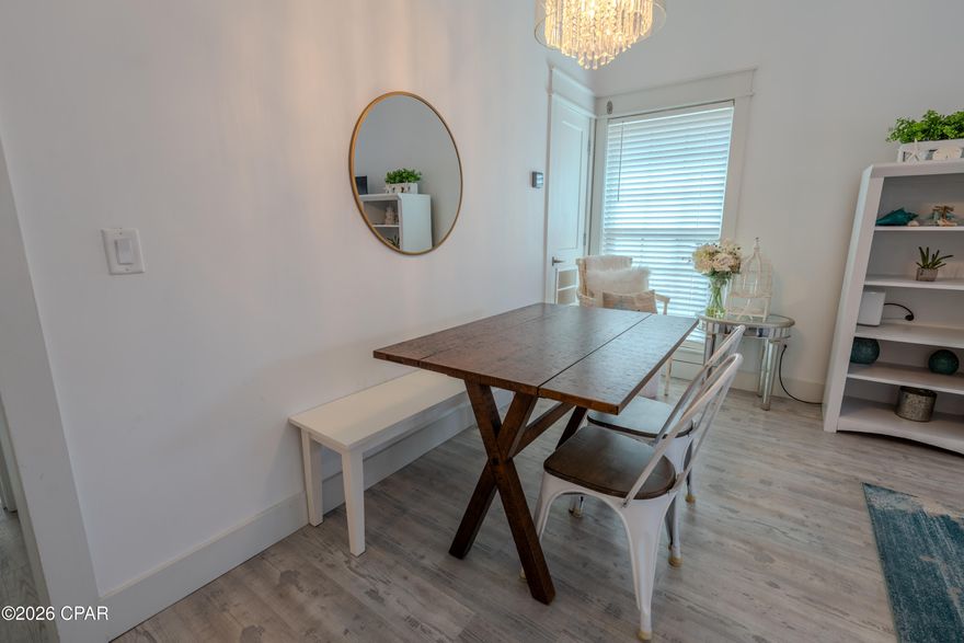 Welcome to this beautifully renovated, first-floor one-bedroom, one-bath villa in the highly desirable Horizon South beach community. Thoughtfully updated and impeccably maintained, this turnkey residence offers a refined coastal aesthetic and is ideal as a primary home, elegant beach retreat, or high-performing vacation rental. The interior is light and sophisticated, featuring white-washed luxury vinyl plank flooring, quartz countertops in both the kitchen and bath, stainless steel appliances, and a vaulted living and dining area that enhances the open, airy feel. There are no popcorn ceilings, reinforcing the home's clean, modern design. Expansive sliding glass doors open to an enclosed and furnished patio with an outdoor shower, creating a seamless indoor-outdoor coastal lifestyle. An electric fireplace and stackable washer and dryer add both comfort and convenience. Major systems including the roof, HVAC, water heater, windows, and sliding glass doors have all been replaced within the last six years, providing exceptional peace of mind. Residents enjoy a short walk or golf cart ride to the beach in this pet-friendly, golf-cart-friendly community that allows both short-term and long-term rentals. Horizon South is known for offering more amenities than any other beach community, including four pools, mini golf, a hot tub, tennis and pickleball courts, a game room, a community center, and a recently updated fitness center. The only thing left to do is arrive and unwind, as the Gulf of America is just a four-minute walk from your door, offering effortless beach access and a lifestyle designed for relaxation.