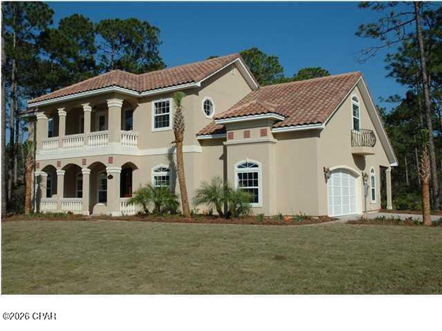 Coming Soon No Showings until end of May. New Photos coming soon this was from Seller when she purchased. Rare opportunity in Trieste, one of Panama City Beach's most private and upscale gated communities, ideally located between Pier Park, the Gulf of America, and St. Andrews Bay. This Mediterranean style residence offers 3,265 heated and cooled square feet, 4248 sq ft under roof .multiple porches, beautiful privacy, and the kind of architectural character that is hard to duplicate today.
Built by Koehnemann Construction as a Parade of Homes entry, this home was designed with timeless details including 10 foot ceilings, a dramatic two story great room, built in bookcases, fireplace, spacious living areas, and an open upstairs family room overlooking the great room below.  
The kitchen is generously sized and features granite countertops, custom hand rubbed stained cabinetry, stainless appliances, gas cooking, and a large walk in pantry. The downstairs master suite offers a trayed ceiling, privacy, and convenience, while the downstairs study could easily function as a fifth bedroom with its own good sized walk in closet.
This home does need updating, mostly cosmetic, including interior and exterior paint and personal design touches, but that is exactly what makes it such a compelling opportunity. Comparable renovated homes in the neighborhood support much higher values, with this property having potential to be worth significantly more once refreshed.
The back porch includes a powder room, ideal for a future pool bath if a buyer chooses to add a pool. Additional features include natural gas, 3 phase electric, stainless appliances, walk in attic storage, Mediterranean charm, and a floor plan that works beautifully for both everyday living and entertaining.
For the buyer who wants privacy, prestige, location, and the chance to create value instead of paying top dollar for someone else's finishes, this is one of the best opportunities currently available in this coveted gated community in Panama City Beach.