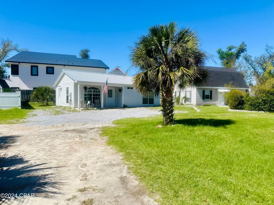 Welcome to Parker Point, your new dream home is nestled just off of the sparkling waters of East Bay. Immerse yourself in the history and charm of this area as you relax on the sandy shore just steps away from a historic Loftin's Ferry landing.

As you approach this stunning property, take note of its lifetime metal roof that adds character and brings the soothing sound of rain to life. Step onto the covered front porch and soak in the tranquil water views before entering through marble-tiled floors into an inviting living room featuring a unique fandelier. The flow continues seamlessly into the dining room and updated kitchen boasting stainless steel appliances, solid wood cabinets, granite countertops, and a convenient side door leading to additional parking and the backyard, complete with a 3-year-old, well maintained AC unit.

The marble tile leads you to an updated bathroom with elegant finishes surrounding both a full bath and shower. Two spacious bedrooms offer plenty of natural light streaming through walk in closets while providing lovely views outside. And don't forget - this home is not in a flood zone! Tucked away off a quiet street but still only 10 minutes from downtown Panama City and less than that from Tyndall Air Force Base, this location is unbeatable!

Let Parker welcome you home as you cruise along in front of your new home each day. Don't miss out on making this oasis yours today - it won't last long!