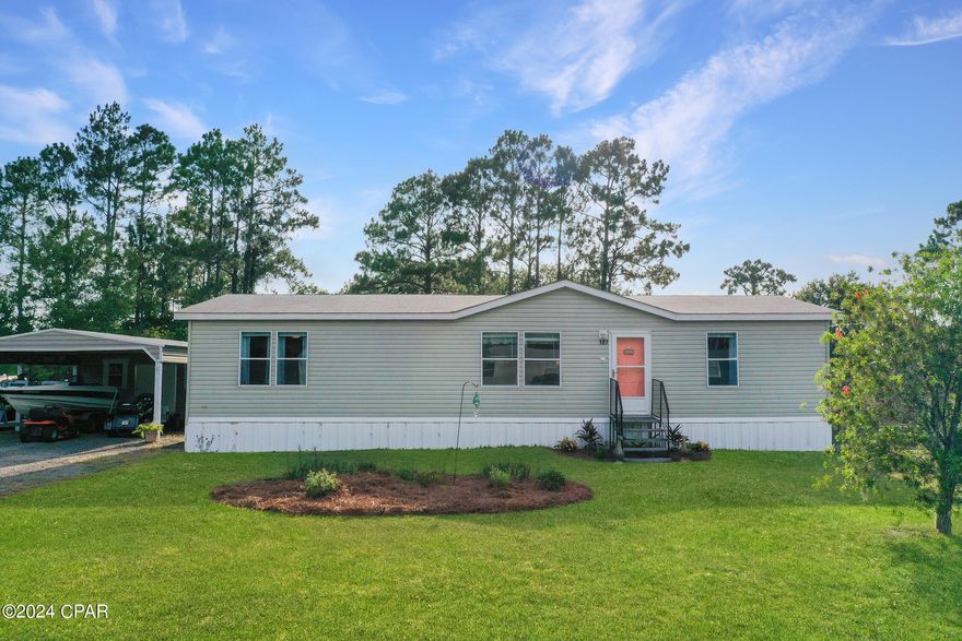 UNDER CONTRACT - ACCEPTING BACK UP OFFERS.  Charming 3-bedroom, 2-bath mobile home sits on a generous sized lot, offering both privacy and space. With no HOA, you have the freedom to truly make this home your own. Step inside to discover a very inviting, large, open floor plan perfect for both relaxation and entertaining. The kitchen is a chef's delight, featuring a spacious walk-in pantry for all your storage needs. The master suite is a true retreat with a double vanity, sitting area and a separate shower. Outdoor living is a breeze with the 12 x 46 screened back porch that is an entertainer's paradise, complete with its own bar, ample space for gatherings, and a dining area. For your vehicles and toys, the 24 x 20 canopy offers perfect parking solutions, whether it's for your car, boat, or other recreational items. Additionally, the 20 x 16 workshop attached to the canopy is a handy space for projects and storage. Whether you're looking to retire in comfort or raise a family in a welcoming community, this home has it all. Don't miss out on this unique opportunity!