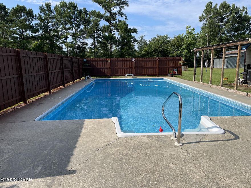 Completely renovated pool house. A three bedroom two bath brick home on a 2.06 acre corner lot this home features a nice open great room with glass sliding doors that overlook a 20 x 40 saltwater pool. The large covered porch and pool is perfect for entertaining. Some features include a on-demand water heater, metal roof, chain-link fence in the backyard and a two car garage. There's a large pole barn with concrete floors with electricity in the backyard. Plus there's a pool shed with a covered area. This home has completely new ceramic floor tiles, all new windows, completely two new bathrooms, new deep sink in kitchen, all new light fixtures with fans, all new paint interior and exterior, all new vinyl on the siding on exterior. New landscaping with landscaping bricks and flowers. Home has a grapefruit, lemon, tangerine and a orange tree and also muscadine grapes. Come enjoy peaceful country live in in the beautiful home located just south of Marianna. No restrictions on farm animals. Interior features include a breakfast bar, pantry, and all ceramic tile floors. Appliances dryer, washer, electric cooktop, electric water, heater, refrigerator with freezer, tankless water heater, dishwasher side by side refrigerator with freezer and ice maker. All updated electrical and plumbing. Owners bought home in 2022 at $220,000 and have spent over $100,000 In renovations. A move in ready home. Very clean and modern! Home will come with a 60' ince zero turn lawnmower that owners bought in October 2022.