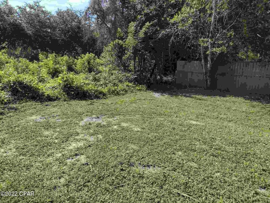 Ready for home: Lot has SEPTIC ON SITE, past services for water, electric. Should be easy to place mobile home on site or build, you will need to get the services in place cleared for re-use.  Prior mobile home was removed after Hurricane Michael.. Improved lot is mowed and has a nice shade tree, driveway, mailbox, so on, was previously established residence.  Land/home purchase or construction loan package financing for VA, FHA, or Conventional is available or just buy this land for cash or lot loan. Beach access is just across Hwy 98, then down  and down to the beaches in minutes.  Easy access is  couple blocks to the white sandy beaches of the popular West End.