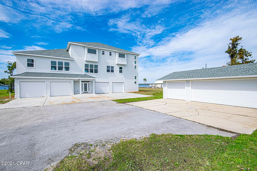 CURRENTLY UNDER CONTRACT, SELLER ACCEPTING BACKUP OFFERS. 3 STORY STUNNING WATERFRONT LUXURY COASTAL HOME with beautiful panoramic views of the bay. First floor in this magnificent waterfront residence features large indoor entertaining space graced by soaring ceilings and wall-to-wall windows and doors with direct access to the pool, half bath and elevator to access the 2nd and 3rd floors. The patio/pool area is the perfect setting for entertaining, dining or just relaxing and taking in the view and spectacular nightly sunsets!



The stairs leading to the second floor boasts large windows with views of the bay. Once you have arrived upstairs stop at the wet bar for a quick refreshment. The large family room has plenty of space to relax and watch the boats as they pass by through the floo access to a full-length balcony. Another focal point is the gas stone front fireplace with TV niche to enjoy when it gets cooler. An added convenience to the main living space is a half bath with pedestal sink and separate laundry room.

This gourmet kitchen will inspire your inner chef and forms the perfect gathering place and features a dishwasher, 2 full size refrigerators, countertop cook top, separate in cabinet oven, warming drawer, 2 sinks, Living Stone countertops, and custom cabinets with storage galore.

The formal dining room has a wall dedicated custom built-in china cabinet and buffet, with a direct serving access pass-through niche from the kitchen to the dining room.

The large master bedroom is located just off the family room and has a gas stone front fireplace with TV niche and large patio doors which lead outside to the balcony. The Master Suite is another noteworthy area of the house and is truly a tranquil retreat! In it, you find a jetted tub, separate oversized double walk-in shower with etched glass door featuring waves and dolphins, double vanity with separate makeup area, and a huge walk-in closet with window for extra light

The 3rd floor boasts a huge recreational space with a wet bar, 3 spacious bedrooms with double closets, large patio doors which lead outside to the balcony, Jack & Jill bathroom with two separate vanities and walk-in shower.

Exterior features include breathtaking unobstructed waterfront views, full length balconies and a boat dock. The driveway has lots of parking and enough room for an RV and two 2-car garages.

There is a beautiful, updated 2nd home on the property that could be used as a mother-in home, guest quarters or even an Air BNB. The possibilities are endless!

Guest House
This beautiful updated 2-bedroom 2 bath home features 2 separate living areas, beautiful, updated kitchen with Living Stone countertops & backsplash, lots of cabinets, new Whirlpool stainless appliances and small dining area. The two ample sized bedrooms are located in the front of the home. The shared full bathroom with tub/shower combo and single sink vanity is conveniently located adjacent to both bedrooms. There is a bonus room with patio doors that would make an excellent office space or 3rd bedroom. There is a detached 2-car garage with a separate golf cart door which has plenty of storage.

Room Info.
Living Room / 11x7
Eat-In Kitchen / 10x17
Family Room / 18x19
Bonus Room / 22x10
Bedroom #1 / 11x10
Bedroom #2 / 12x 11
Bathroom / 7x8
Laundry Room / 10x7

All sizes, ages and measurements are approximate; buyer to verify if important.