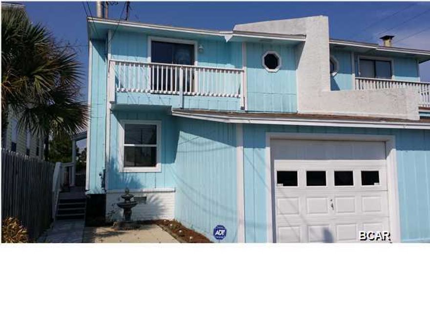 LOCATION,LOCATION,LOCATION, walk 2+ blocks to the public beach access from this spacious, 3B/2B duplex style townhome with a garage,front deck, 2 rear decks, and fenced back yard, all on a corner lot. Updates include new kitchen cabinets, new quartz countertops,recessed lighting,energy efficient windows,new tile downstairs and upstairs bathroom, new vanities and granite sinks in both bathrooms, and new lights and mirrors in both bathrooms. NO ASSOC FEES, Also within walking distance to Grand Lagoon and many public boat launches. Call for a private showing today. Being sold ''as is''. All ages, sizes, measurements are believed to be accurate, buyer should verify.