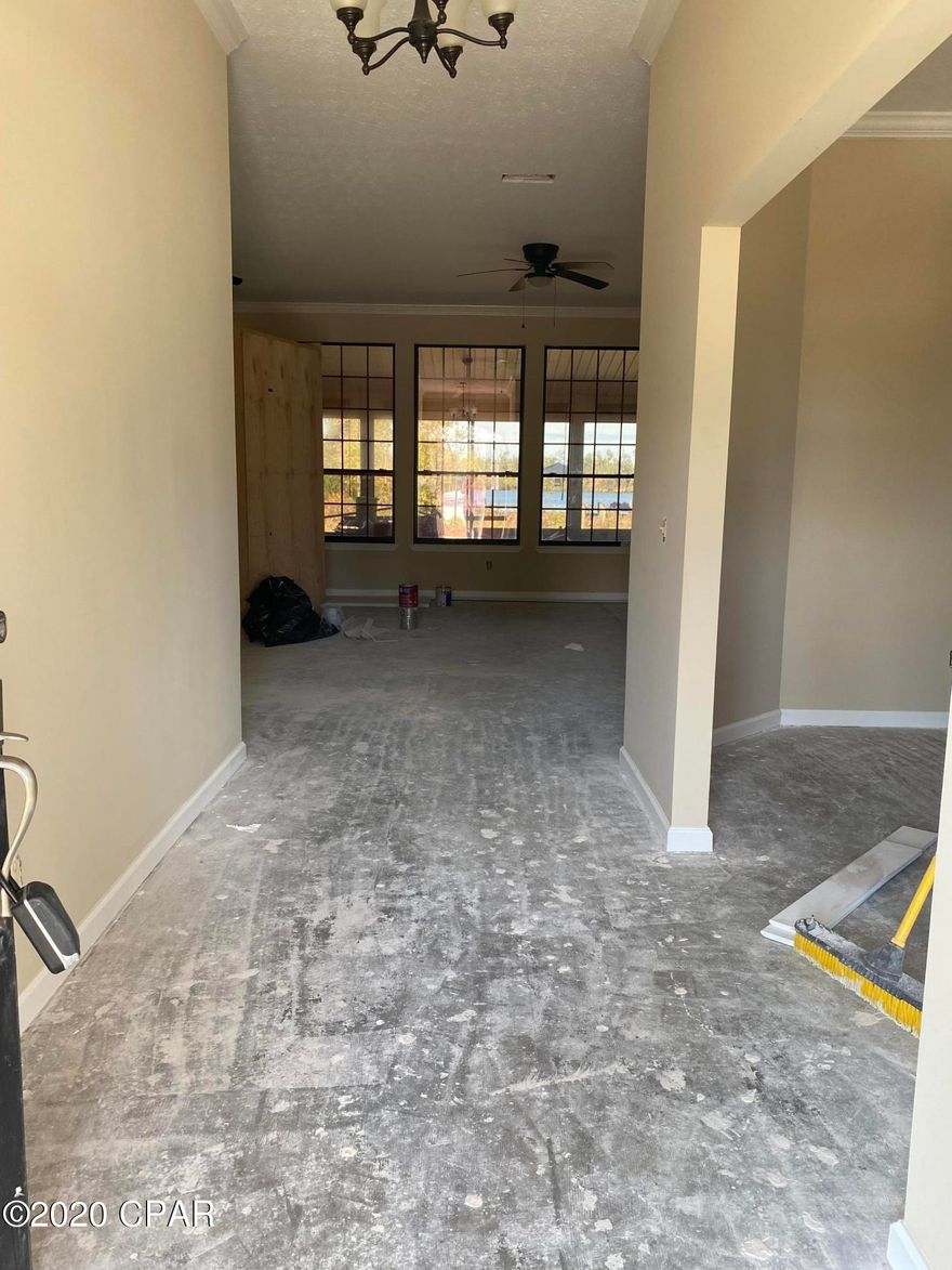 This magnificent Deerpoint Lake home is situated on 200' of deep water on the lake and equipped with a dock and covered boat house.  The home is in need of flooring, windows and a new kitchen.  Refurbish the existing custom kitchen cabinets or bring in new ones of your choice.   Reconstruction from Hurricane Michael was started but never finished.  Roof replacement, dry wall, interior paint and interior doors have been installed.  Once put back together, this beautiful waterfront home will provide gorgeous sunset views of the lake from the master bedroom, living room and kitchen.  Call your realtor today to see this one! If sf is deemed important to buyer, please measure.