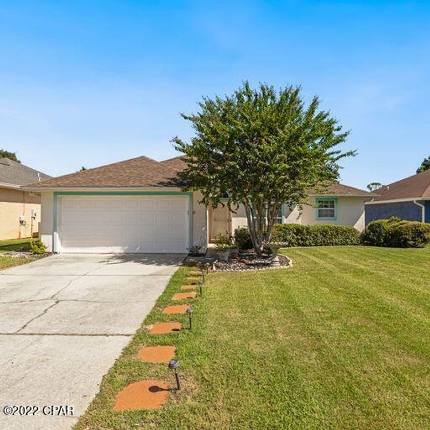 . This is the quintessential beach house! Take a short 5 minute stroll to the beach or jump in your golf cart. About 2 miles away is Pier Park with all the restaurants and shopping. This contemporary styled, split floor plan, upgraded home is situated on a cul de sac street that has underground utilities (no ugly wires hanging down) . The split plan is all tile with a spacious master bedroom and walk in closet. The bathrooms and kitchen are upgraded to maple hardwood cabinets with soft touch technology. All the faucets are Delta ORB including the touch-less professional grade Delta faucet in the kitchen. Bonus large Sun Room heated and cooled lots of windows. All counter-tops in the bathroom and kitchen are matching neutral granite.Master bath has his and her sinks. The roof is architectural 30 year shingle, installed in December 2015, mew AC system 2020. The baseboards have all been replaced with 5 inch genuine hardwood and all hardware for the doors is ORB, contributing to the overall charm of this home. French doors lead from the living room to the large sun room/family room. Master bedroom has walk in closet. The spacious back yard is totally fenced in with mostly Vinyl fencing. Two car garage!  The house currently and always has been under a termite bond with Florida Pest Control. This is a great primary home or second home for the family that would enjoy a quality home with a very centralized beach location. This home is better than many new homes.