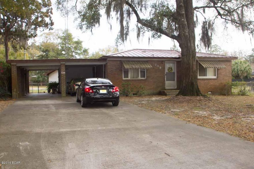 This lovely home located in the heart of beautiful Lynn Haven on a large corner lot is ready for a new family.  This is a well built brick home, yes, a few updates are needed but it has some great features.  This home has 3 bedrooms, 2 baths, a formal living/dining combo and a family room or den, there is a lot of room to relax.   There are lovely moss filled trees on the property, a sprinkler system in the front yard that runs on a well, a 2 car carport, a large workshop and a separate shed in the back yard.  The AC unit was replaced 2 years ago and it has a low maintenance metal roof.  Go take a look at this little gem and you are sure to fall in love with its charm and character.