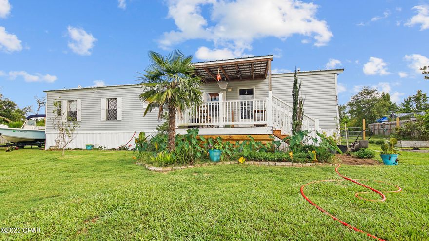 Beautiful mobile home located on 1.68 acres. Newer metal roof. Low cost Well system with water softener treatment system. The home offers a large covered front deck 12x20 and a Large 12x30  back deck. The 10x15 enclosed shed will convey with the property! The kitchen offers plenty of cabinet space with an open layout. Partially fenced back yard with a pond!