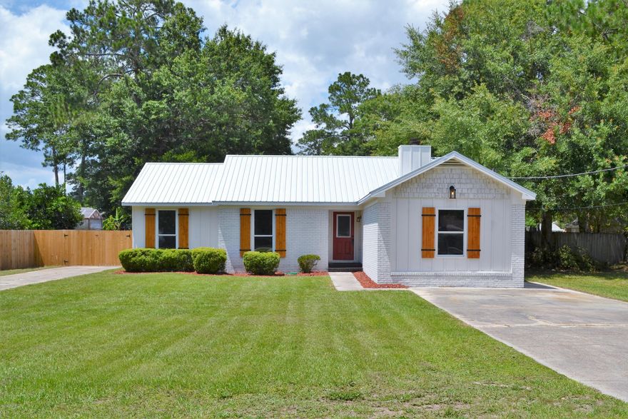 BEAUTIFULLY FINISHED HOME NEAR TYNDALL AFB WITH IN-GROUND POOL. The interior of this stylish home features 4 bedrooms (or 3 bedrooms and a 2nd living room), 2 full baths, an open floor plan, interior washer/dryer hookups, and a screened-in porch. The completely remodeled kitchen boasts granite counter tops with breakfast bar, new cabinets with soft close drawers, a subway tile back splash, a custom hanging wine glass holder, new stainless steel appliances and a pantry. The living/dining room is open to the kitchen and has attractive laminate floors, a wood burning fireplace and custom shelves to match the hanging wine glass holder. The master bedroom overlooks the pool and has an adjoining bath with new vanity, new fixtures and a new walk-in tiled shower with small cobble stone flooring. The 4th bedroom could also be used as a 2nd living room, media room, guest room, etc. All bedrooms have new neutral carpeting. The hall bath has a new vanity, new fixtures and a new shower/tub combo with subway tiles. 
New since 2016: HVAC, Roof, Paint inside and out, Light Fixtures, Flooring, Kitchen, Appliances, Bathrooms, etc. The exterior features an in-ground chlorine pool with separate jetted tub (not heated), a 100x127 lot, a privacy fenced backyard, a 2nd driveway with gate for backyard vehicle/boat/RV parking, custom stained wood shutters, an open back patio and new landscaping. The pool has new equipment and a pool cover with the screw in grommet system (conveys). Call today for your own private preview. All information derived from seller and public record, measurements approximate