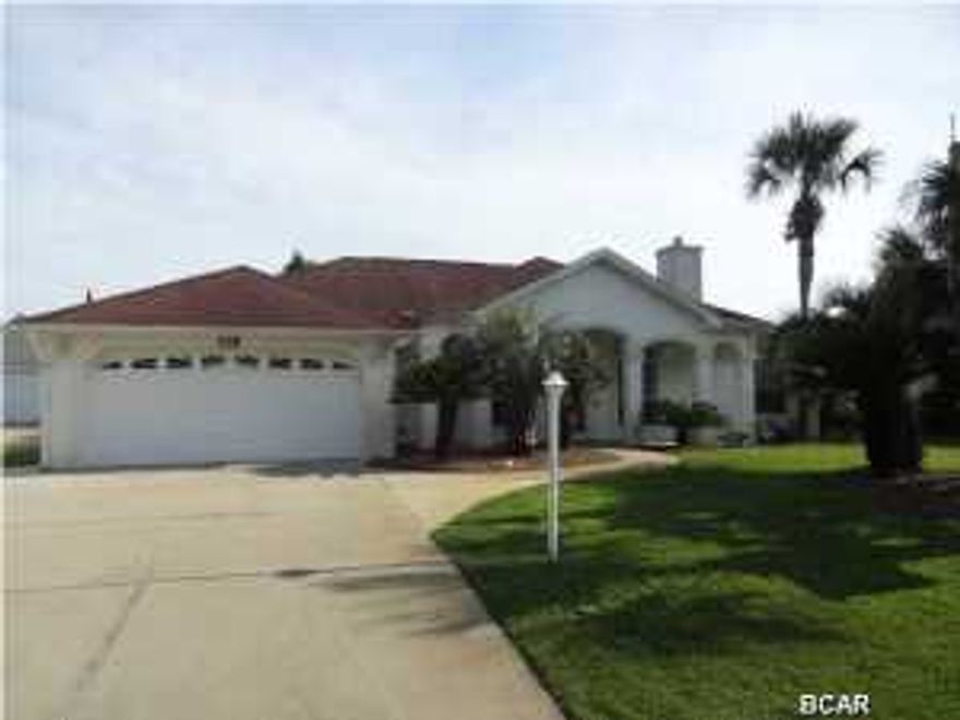 Opportunity abounds with this 3 bedroom 2 bath home located on the west end of Panama city beach in the Southfield's community. A wonderful split bedroom floor plan with a bonus room that would make a great 4th bedroom or office area. The master bedroom opens onto the pool area and the master bath has a number of nice features such as; both a large shower and a separate Jacuzzi tub; double sink vanity, large walk in closet and linen closet.The kitchen has a large pantry and is open to the living area and the lanai area of the pool and Jacuzzi.. The living room has plenty of space and a fireplace to boot! Parking galore at this home with its double car garage and the additional parking area for your boat or Rv. The back yard is completely fenced and has a workshop with covered patio