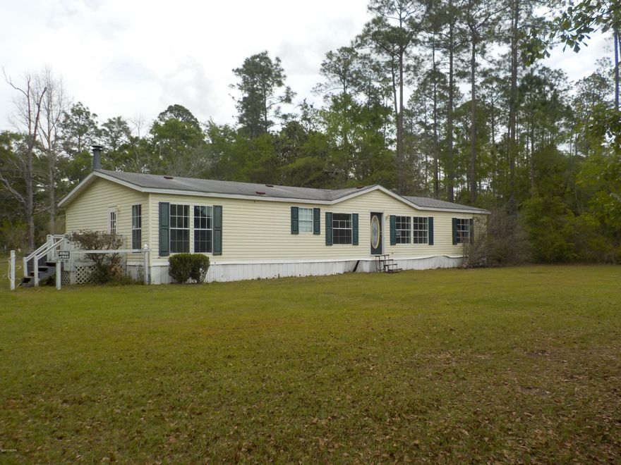 Looking for something a bit out of town? Take a look at this fantastic, priced to sell, double-wide manufactured home on 1 acre! This large, 1782 sq ft home features a living room, family room with fireplace, open floor plan, large kitchen with island and tons of cabinets, breakfast area, laundry room by the back door and 3 nice sized bedrooms and 2 full baths. Popular split bedroom plan! Priced to sell - not too far from town, but far enough to feel a little country and have a little extra elbow room! (all sizes approximate and taken from public records, buyer to verify any details buyer deems important).