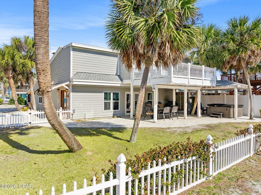 Prime Gulf-View Coastal Retreat
Perfect vacation rental, second home, or permanent residence, directly across from private Beach Access #13 in an exclusive neighborhood blending year-round residents, luxury retreats, and elite rentals. This 6BR/4BA block home with HardieBoard siding spans 2,700+ sq ft, sleeps 18 comfortably, and delivers turnkey rental income.  

Open-Concept Luxury Living
Stunning professional décor highlights an expansive great room with 18ft beamed ceilings, wood-burning fireplace, and seamless flow from living to dining to well-appointed kitchen.  Granite countertops, steel-blue cabinetry, and stainless-steel appliances elevate meal prep, while French doors from the Florida room open to a resort-style outdoor oasis.

Outdoor Entertaining Paradise
Cedar pergola shades a large dining table, bubbling Hot Tub, and breezy seating - ideal for Gulf-breeze grilling on the gas BBQ amid family gatherings. Fenced yard, dual outdoor showers, and abundant parking complete the private outdoor haven, just steps from the sand.

Spacious Bedrooms and Suites
On the main level, accommodations include a private 1st-floor primary suite, offering canopy queen bed, sleeper sofa, and full bath.  Additionally, a 1st guest bedroom with king bed, 2nd bedroom with queen bunk bed connected via Jack & Jill bath.  The 3rd and 4th bedrooms, each with queen beds are also linked by their own Jack & Jill bathroom.  This home sleeps up to 18 guest comfortably.  The spiral staircase and modern railings lead to a private suite on the 2nd floor which features a jetted garden tub, large walk-in shower, and private balcony to enjoy the sunrise, sunsets and gulf views.

Additional Features
Fully furnished, rental ready, plenty of parking, 2 outdoor showers, HOT TUB, outdoor seating, fenced yard, tiled floors on entire 1st level, laundry room, block house with Hardieboard siding, connected to the city sewer, roof was replaced in 2019, (two HVAC systems,  two water heaters and kitchen appliances were replaced in 2018), steps away from the beach.