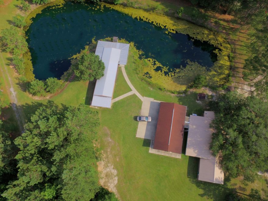 Find peace and freedom in the open spaces of this country retreat. Located less than 30 minutes from the Panama City Beach and Northwest Florida Beaches International Airport. With a total of 6 bedrooms and 4.5 bathrooms situated on 2.5 cleared acres, this home features multiple heated and cooled living spaces and work areas perfect for hosting large groups. From the large workshop and man cave to the separate summer house with huge screened porch overlooking the private stocked pond, there is something here for everyone. Well-maintained with recent metal roof and gutters, with many updates and additions. With an oversized 3-car garage and several extra storage areas, everything you need to enjoy a relaxing weekend will be at hand.