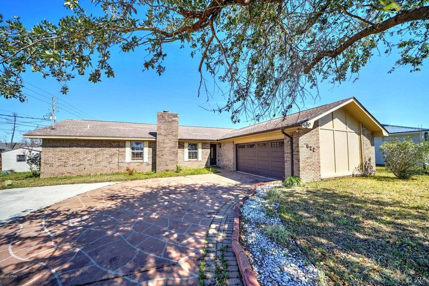 NEW ROOF, PAINT, FLOORING AND MORE! Recent updates to this Centrally located 3 bed, 2 bath home with a POOL! This home has a large living room boasting a fireplace and beamed ceilings.  The kitchen is equipped with stainless appliances, plenty of cabinets for storage, and a built-in desk. This home has a split bedroom floor plan with the master suite on the West end. The master bath has a shower/tub combo. The two guest bedrooms are on the East end and share a full guest hall bathroom also with a tub/shower combo. French doors off the dining room lead to the spacious backyard. The inground pool has a nice screened in housing. The backyard also has a small brick courtyard and shed. Large 2 car garage offers extra storage space.