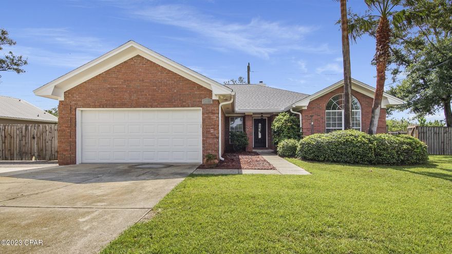 LYNN HAVEN HOME - The interior features 3 bedrooms, 2 full baths, a semi-open floorplan with split bedrooms, 2 dining areas, an interior laundry room, and a 2 car garage.   The kitchen has granite countertops with a breakfast bar, stainless steel appliances, 2 ovens, and a pantry. The master bedroom is large and has an adjoining bath with two walk-in closets. The exterior features a 100x150 lot, a privacy fenced backyard with a double gate for boat or RV parking, an extended driveway, a covered back porch and a paver patio.  Public School Zone: Lynn Haven, Mowat, Mosley.  Golf Cart Community!  Available Now!