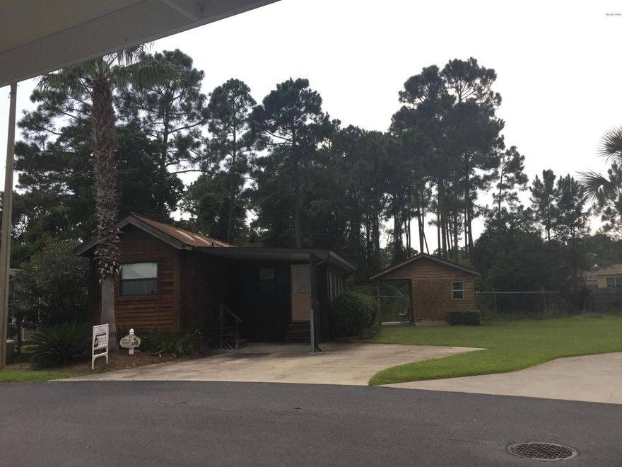 WHAT A GREAT DEAL!  This 1bd/2ba modular home is on a permanent foundation.  It is situated on the largest lot in subdivision.  It comes totally furnished and equipped, move in ready!  Washer/Dryer hookups in kitchen for stackable unit but also in 10x12 outbuilding is a side by side with utility sink.  This gated community resort is across from navy base and has 2 pools, hot tub, lake, clubhouse, fitness center, and boardwalk.  A must see!