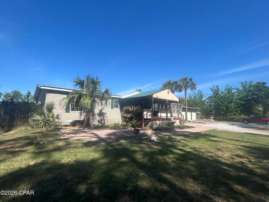 Spacious 3BR/2BA manufactured home offering 2,432 sq ft of comfortable living in a peaceful country setting--just 4 miles from Lynn Haven. This home features oversized bedrooms, each with large walk-in closets, and a relaxing primary suite complete with a soaking tub.
The open-concept layout includes a generously sized kitchen with a large island--perfect for entertaining--along with all new appliances installed in October 2025. Cozy up by the wood-burning fireplace or enjoy quiet mornings on the screened front porch.
Additional upgrades include a newer water heater (2024) and underground electric utilities for added safety during storms. Outside, you'll find an oversized 3-car garage, two storage sheds, and a huge backyard with plenty of space for chickens or other animals.
Located just 0.4 miles from a convenient boat ramp on Fanning Bayou. This property offers the perfect blend of country living with easy access to the water and nearby amenities. The home needs new floor covering in all rooms except the primary bathroom, which is tiled. There is new plank tile flooring in the garage available to be installed. All dimensions are approximate. Please measure if important. Lender financing is available.