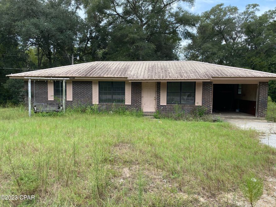 Diamond in the ruff and priced right! Check out this cute little brick ranch home with metal roof on over an acre with a large pole barn in the back of property. Located on a paved road and only 19 miles from Defuniak Springs, 12 miles from Bonifay and 48 miles from Panama City Beach. Only 4.7 miles Caryville exit 104 and Interstate 10. Just needs some TLC to make it your own!