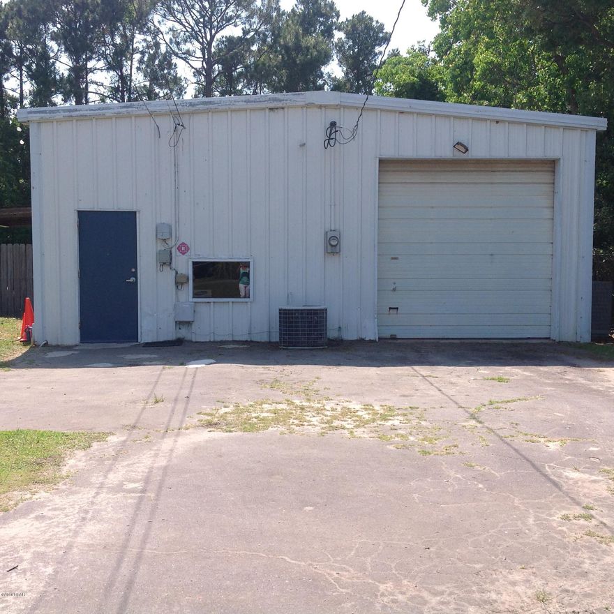 Large metal building featuring 3 roll-up doors for easy access.  Office area and large workshop/storage area.  Entire building is heated and cooled with a central unit.  Newer electric and fully insulated.  Large cleared lot offering lots of options.  

Seller will consider OWNER FINANCING with 25% down, balance amortized for 15 years @ 5.5% with 5 year balloon.