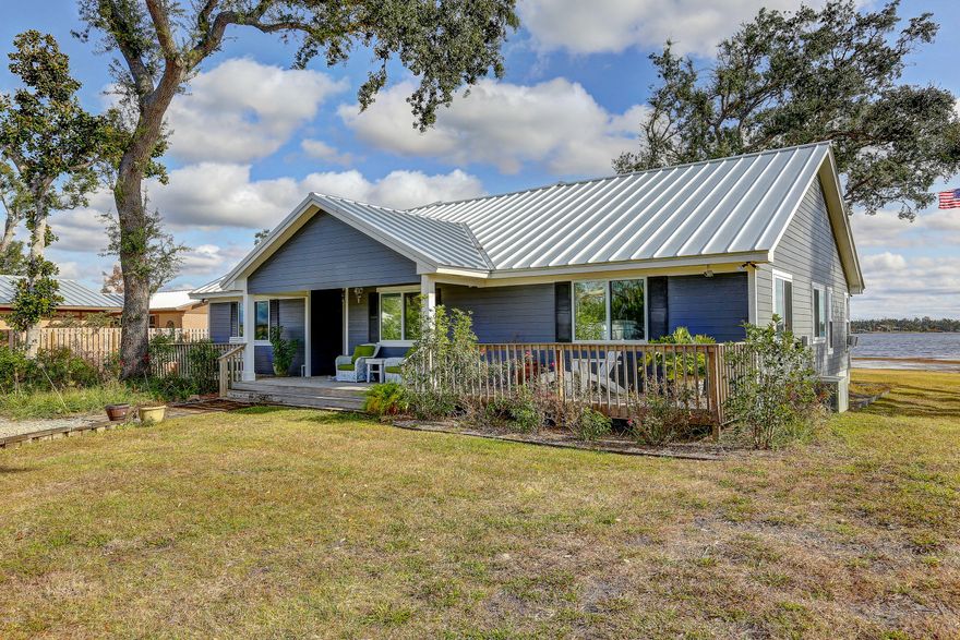 CURRENTLY UNDER CONTRACT, SELLER ACCEPTING BACKUP OFFERS. Florida cottage with incredible views on the main part of Deerpoint Lake. 2 BRs, plus an office (or 3rd BR) and 2 full baths. Open concept offers an entertainer's kitchen with large granite island, wine cooler, huge pantry, great room with fireplace, built-ins, and lots of natural light. Views of Deerpoint Lake from almost every room. Step out onto the expansive screened porch or walk down to the dock for your morning coffee or evening cocktail. Soak up the surrounding nature. Go fishing or enjoy a boat ride!  Home has original cement floor, stained and sealed. New hit & miss fence allows wind to pass through while maintaining privacy. Electric gate for security. All measurements and dimensions approximate - plz verify if important.