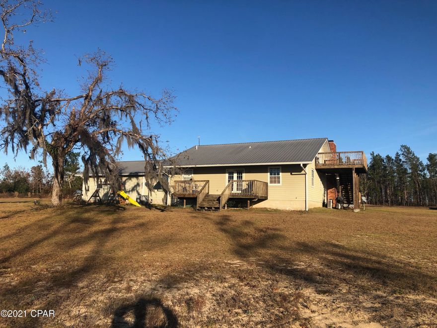 WOW!! 3,000 sq. ft. +/- 4BR / 3.5BA of peaceful, secluded country living. This home features an open concept with stone fireplace, updated kitchen with granite countertops, stainless appliances and a basement that can be utilized as a recreational area or storm shelter. The second floor bedroom has its own entrance and bath. A 28x28 garage that has been converted to a workshop with its own AC. Outside, you can enjoy your morning coffee on the covered front porch or open back deck that overlooks the pond. This won't last long. Call your favorite Realtor today to schedule your showing. Measurements are approximate, verify if important.