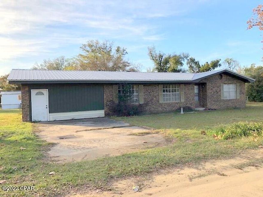 CURRENTLY UNDER CONTRACT, SELLER WILL CONSIDER BACKUP OFFERS-Large brick house in conveniant location between Hwy 231 and Hwy 390 with new metal roof in 2019 on large corner lot over a half acre with large shed/shop and covered parking area. Covered patio. Great first home or rental investment, with rental potential around $2,000 monthly. Four bedrooms with two full baths and a half bath in 4th bedroom. 4th bedroom has available a seperate entrance and could be used for office or business. Large family room with wood burning fireplace. House has lots of potential. The seller is willing to negotiate credits for painting indide and flooring replacement. The two vehicles on property will be removed before closing. Buyer to verify all information.