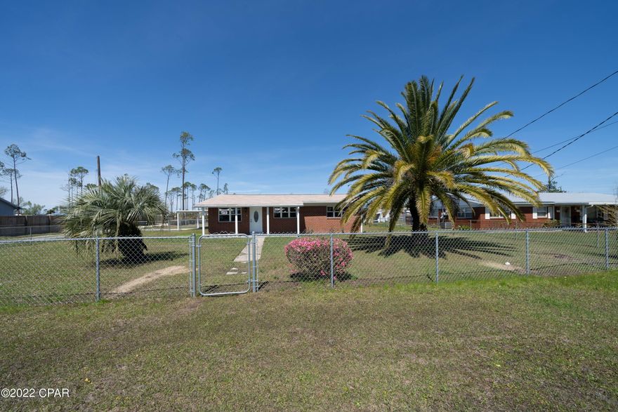 Don't wait to see this beautiful 3 bedroom, 2 bath home! It sits on almost half an acre lot that is completely fenced and has plenty of room for the kids to play; or to store your boat or RV. The house has tile floors throughout the living areas and new carpet in the good sized bedrooms. The updated kitchen has stainless appliances and opens to the spacious living room. In the back of the house there is a Florida room that would make a perfect den or play room for the kids. The laundry room is large enough to double as a craft room or office. The location is just minutes from Tyndall Air Force Base; and is convenient to schools , shopping and restaurants. The drive is shared with the neighbor. All measurements are approximate and should be verified if important.