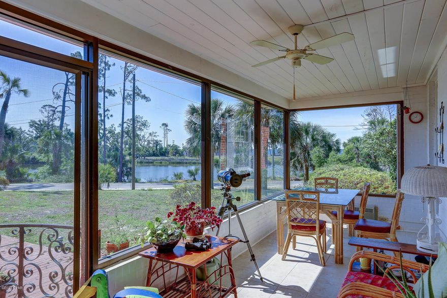 Views of Lake Caroline and St Andrews Bay can be seen from multiple rooms in this St. Andrews home off Beach Drive.  Enjoy the sandy white shoreline for a sunset walk or take a relaxing bike ride to downtown St. Andrews and waterfront marina area for shopping and events.   This brick 4 bedroom 2 bath home has the charm of yesteryear in a beautiful natural setting.  The backyard is a gardeners dream with trees for shade over flowerbeds and focal points all wrapped in privacy giving it the feel of a ''Secret Garden''.  Entry through a backgate on Bakers Court give many options for recreational vehicles and just easier access.  There are two living spaces, one overlooking the water with hardwood floors and one overlooking the garden with terrazzo, both with focal fireplaces.  A front Florida Room is the perfect place to enjoy a meal or take your morning coffee with your laptop.  Something you don't see is a true master suite that can be closed for privacy and has the master bedroom, master bath and two seperate dressing rooms lined with closets and dresser drawers and mirrors, each has great lighting.  There are storage closets throughout the home, some have built in drawers for perfect organization.  The kitchen is large with hardwood floors and plenty of cabinets, granite countertops and high ceiling.  Central in the house for great entertaining.  If waterfront living is your dream, come see this house today!