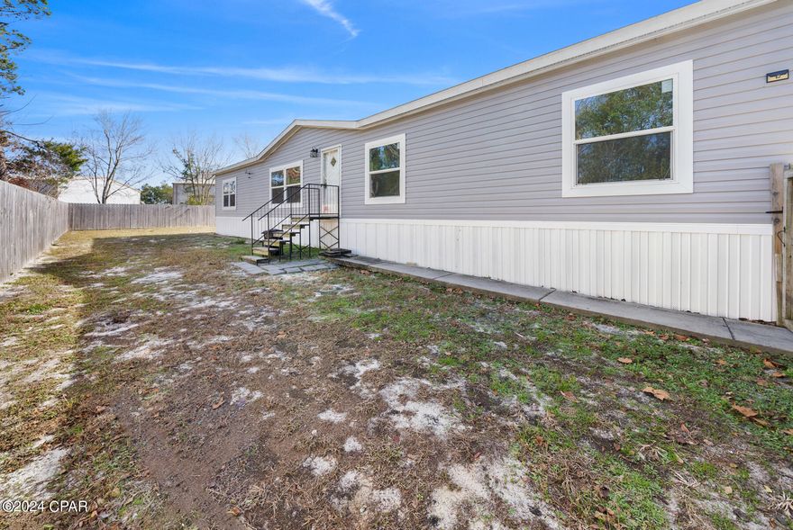 Looking for more space on the west end of Panama City Beach! You have found your spot!
This spacious mobile home has 5 bedrooms and is less than a mile from the sandy beaches and just minutes to Frank Brown Park, the shops at Pier Park and more. Fenced in yard allows for privacy and freshly painted walls and brand new LVP flooring throughout provide an nice atmosphere. Call today for a showing.